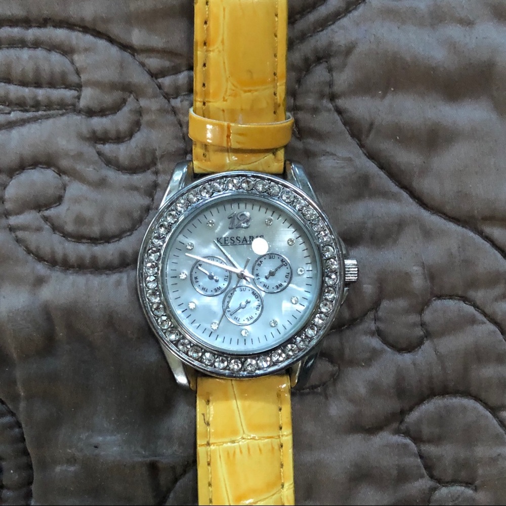 Decorative watch with yellow strap and pearl face